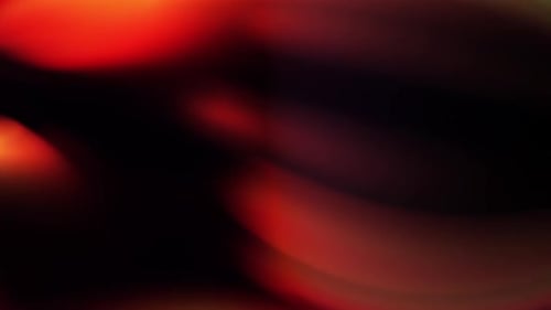 a blurry image of a red and yellow object with a black background