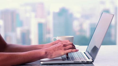 hands typing on laptop,