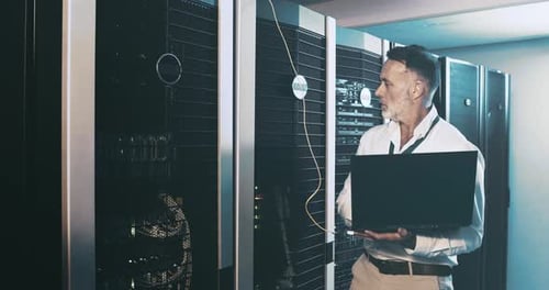 Mature man in server room with laptop, network maintenance and engineer in digital storage