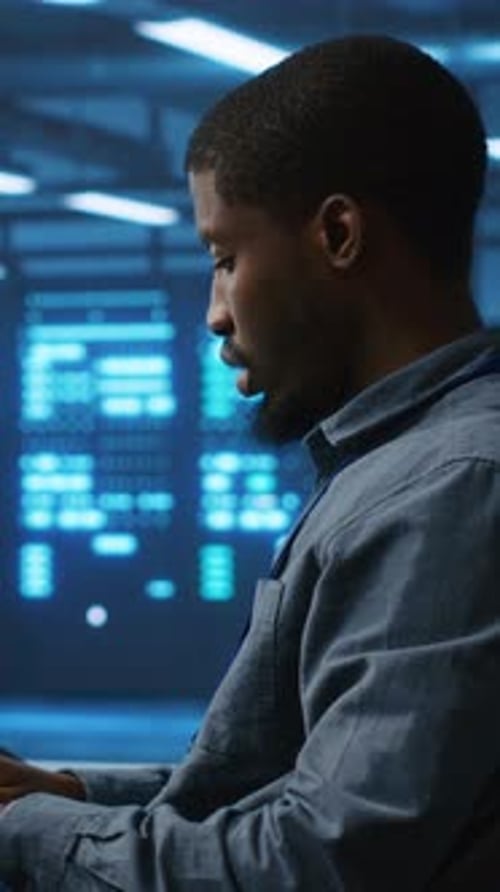 Focused Man Works in High Tech Server Room