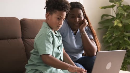Woman and Child Using Laptop at Home