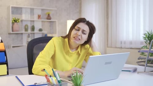 Tired Woman Working on Computer at Desk