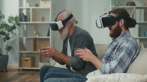 Senior and Young Adult Play VR Video Game