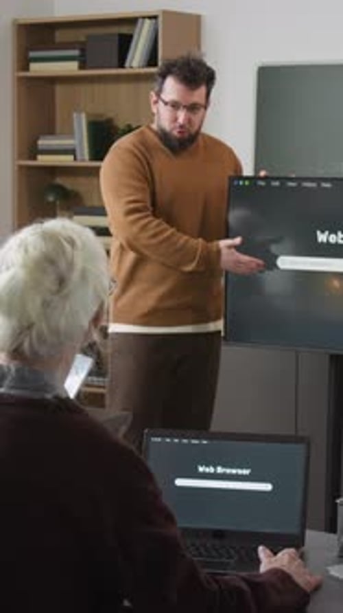 Vertical Shot of Man Teaching Internet Basics in Computer Class