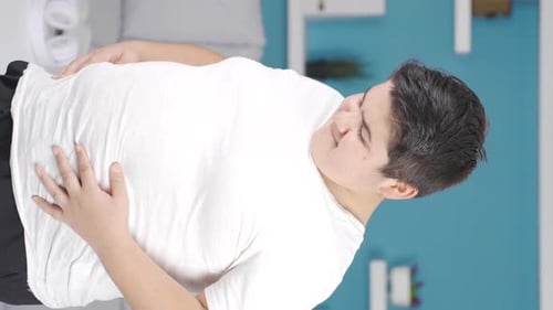 Young Man Clutching His Stomach in Pain