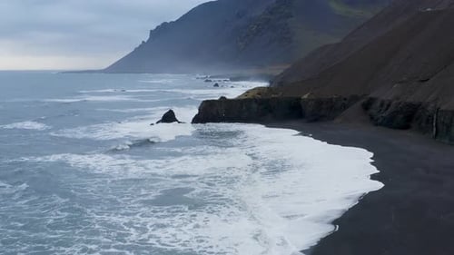 Flying Through The Beautiful Coastline Of Black Sand Beach In Iceland. - Drone Aerial Shot