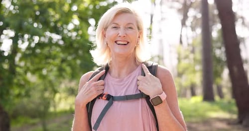 Smiling Senior Woman Hiking in Nature