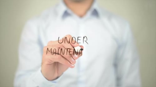 Under Maintenance Man Writing on Transparent Screen