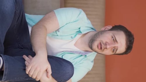 Vertical video of Sad man crying at home.