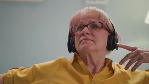 Senior Woman Listening to Music with Headphones