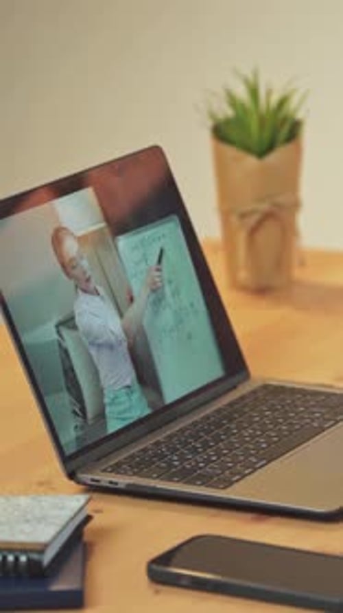 Vertical Video View on a Laptop Screen Woman Teacher Makes a Homeschooling Online By Video Call