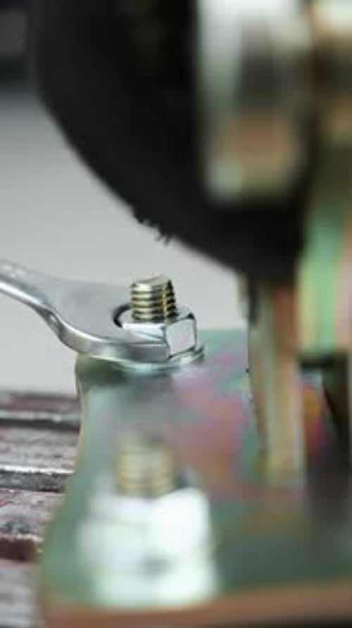 Tightening Bolt with Wrench on Metal Base