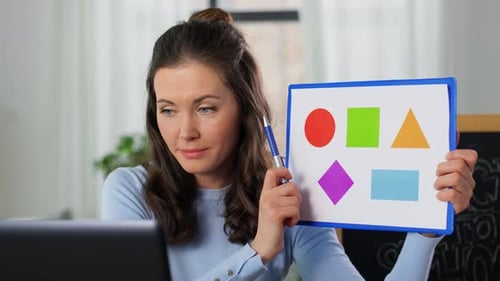 Woman Teaching Geometric Shapes Online with Laptop