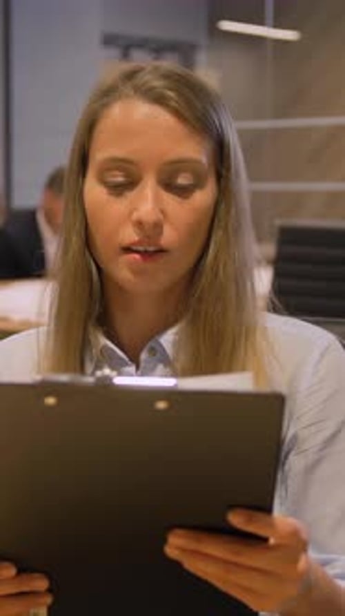 Vertical of Businesswomen in Modern Night Office Interior Working They Discussing Deal Questions