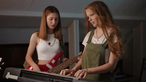 Slow Motion The Girls on the Synthesizer and Bass Guitar Experimenting with Sound and This Causes