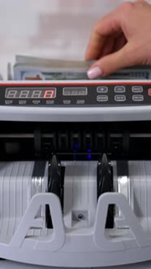 Money counting machine. Counting dollar banknotes. Vertical video