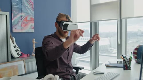 Young Man Interacting with VR Headset in Office