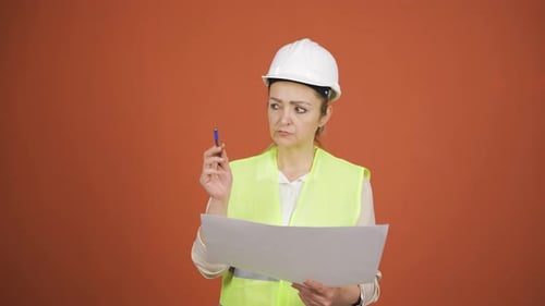 The engineer examines the project in her hands.