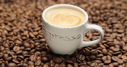 Coffee with Swirls Panning Close Up on Coffee Beans