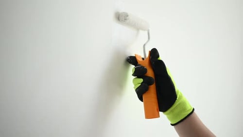Worker Painting Walls White