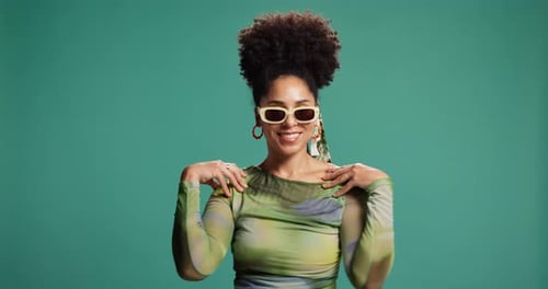 Happy woman, fashion and studio with style for clothing or outfit on green background