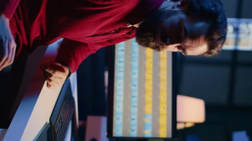 Young Adult Working With Computer and Phone