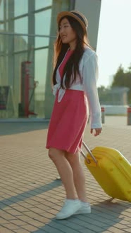 Young Adult Walking with Suitcase