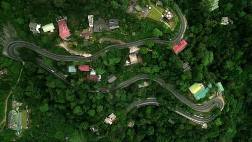 Winding Mountain Road Snakes Through Rich Sri Lankan Highlands Vehicles Navigate Tight Turns Amid