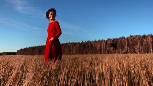 Woman in Red Dress in Golden Wheat Field