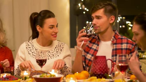 Friends Eating Dinner and Drinking Wine at Home