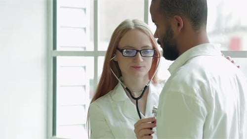 Doctor Listens to Patient Heartbeat with Stethoscope
