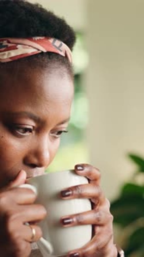 Woman Smiling and Enjoying Coffee Indoors near Window