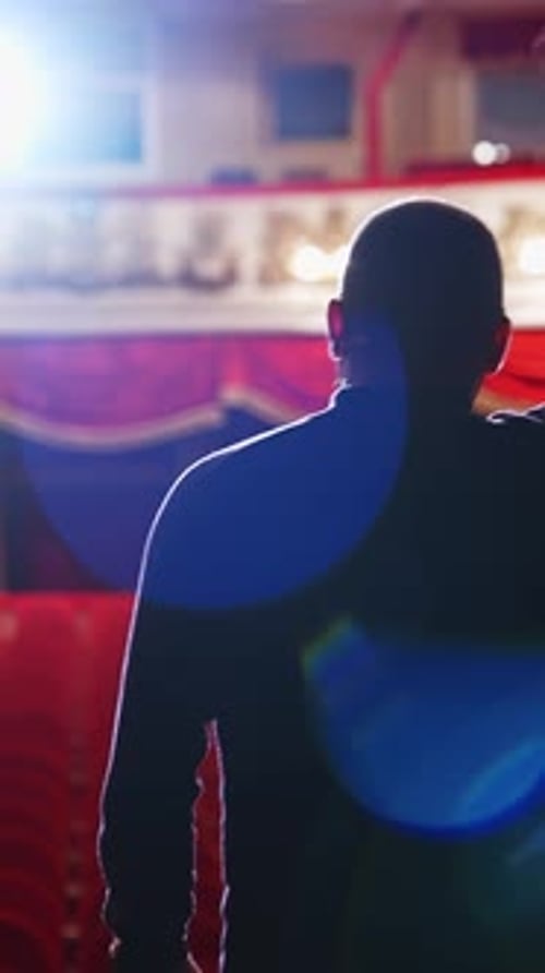 Theater auditorium with no people. Actor on a stage in front of empty hall. Vertical video