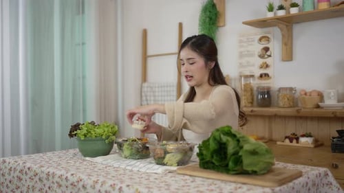 Young Woman Preparing Salad in Sunny Kitchen