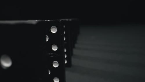Dominoes Falling in Chain Reaction