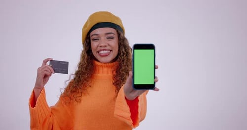 Happy woman, phone mockup and credit card in online shopping or advertising against a studio