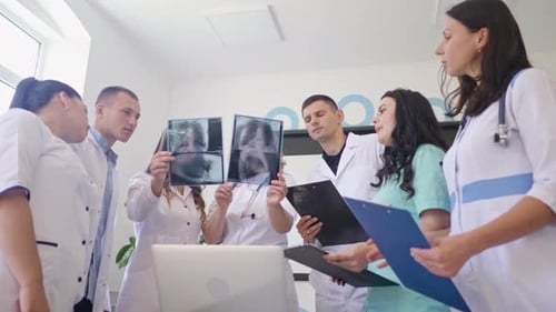 Medical Team Analyzing X-Rays in Modern Hospital