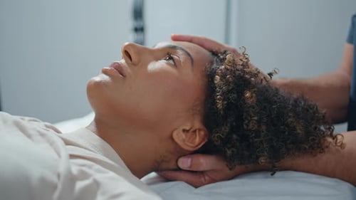 Woman Lying Physiotherapy Couch Closeup Clinic Patient Opening Eyes with Relief