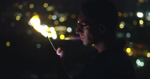 Millennial 30s Man in Glasses Scroll Internet on Smartphone on Backdrop of Night City