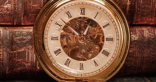 Golden Pocket Watch and Stack of Books