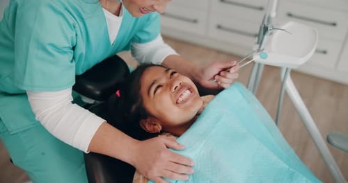 Dentist Checking Child's Teeth in Dental Clinic