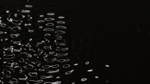 Black Water Surface Monochrome Moving Waves and Ripples Under Ultra Sound Vibrations Abstract