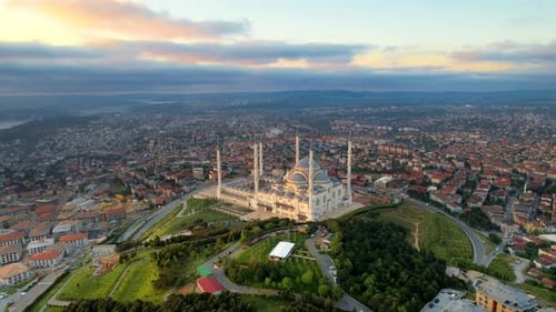 Aerial drone view of Istanbul at sunset, Turkey. Camlica mosque with multiple buildings around, gree