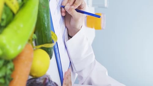 Doctor Writing Diet with Fruits and Vegetables