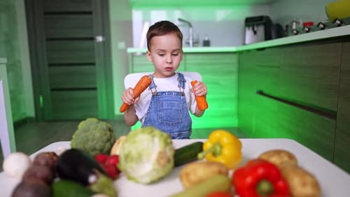 Adorable Boy Holds Carrots Surrounded by Colorful Vegetables