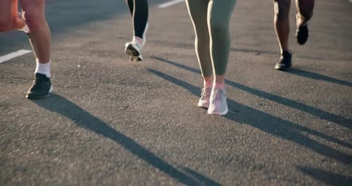 People, legs and running on road in exercise, outdoor fitness or cardio training on asphalt