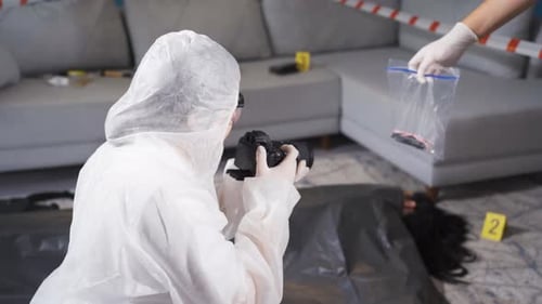 Crime Scene Investigator Photographs Evidence at Crime Scene