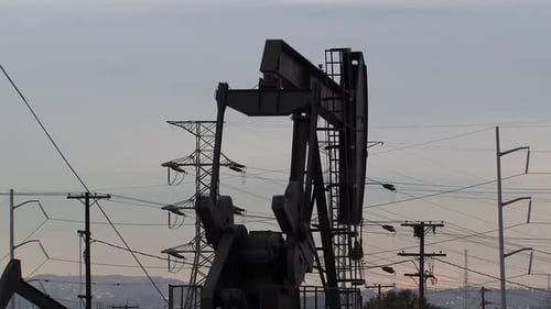 Oil field with oil pumps in Los Angeles in the evening, California, USA.
