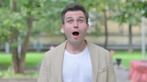 Man Reacts with Joy and Celebrates in Park