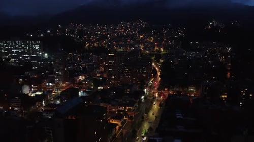 Aerial night view in Bogotá, Colombia, between clouds, cars and lights